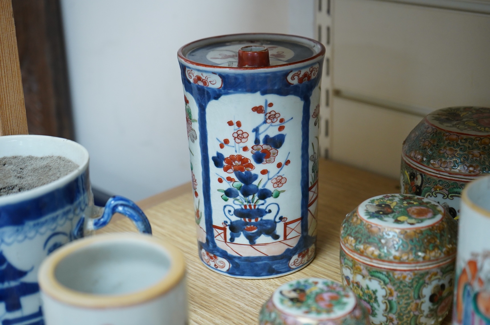 A collection of Chinese ceramics to include a blue and white mug, set of three graduated Canton jars and covers and two cylindrical brush washers